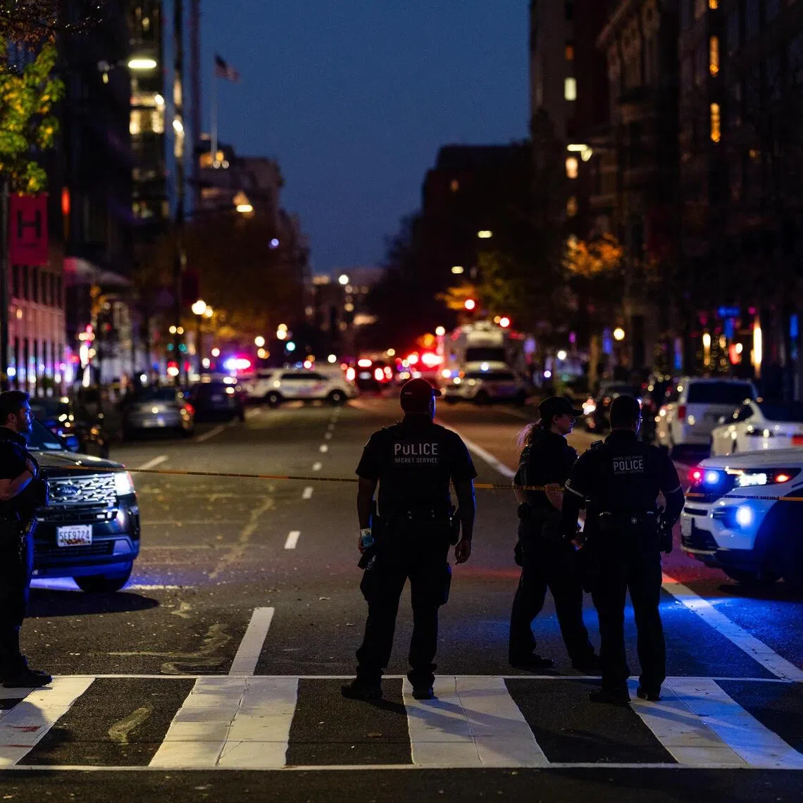 Members of various law enforcement agencies are at the scene where two members of the National Guard were shot in Washington on Nov 26.