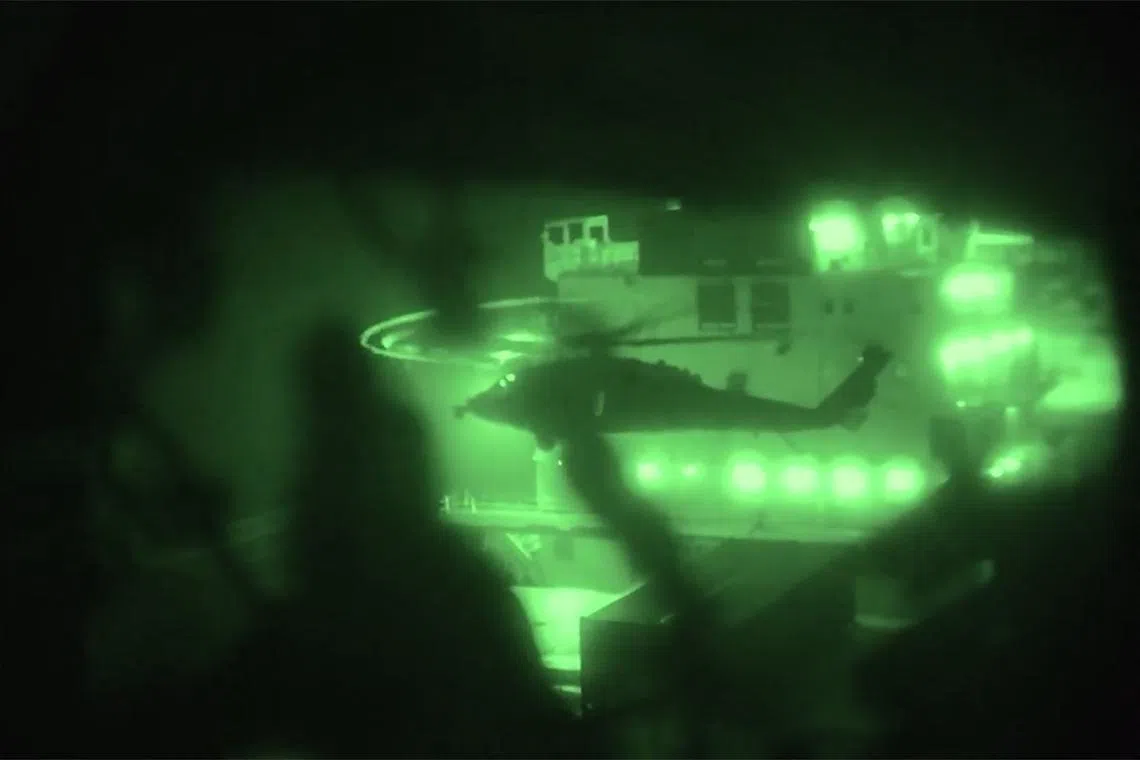 This screen grab obtained from a video released by the US Central Command shows US Marines boarding and seizing the Iranian-flagged vessel M/V Touska after departing by helicopter from amphibious assault ship USS Tripoli in the Arabian sea on April 19.