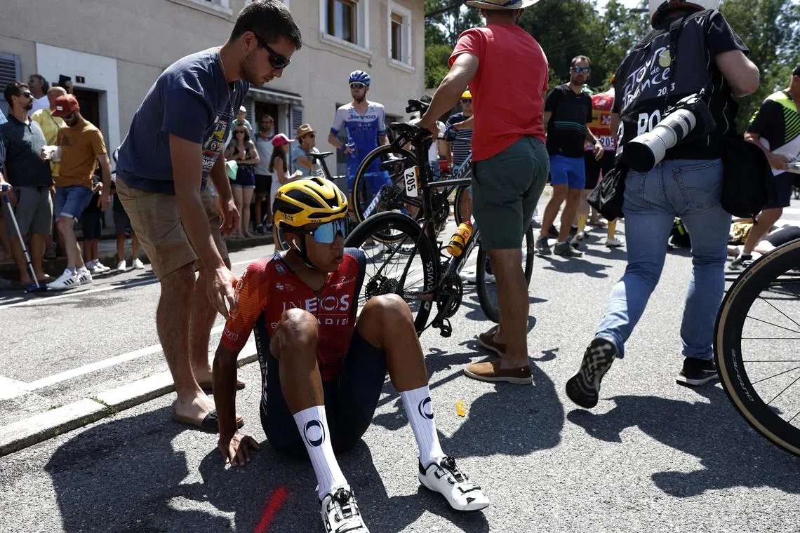 Egan Bernal being assisted on Sunday after crashing in the Tour de France's stage 15 and his Ineos Grenadiers team have called on spectators to “give the riders room to race”.