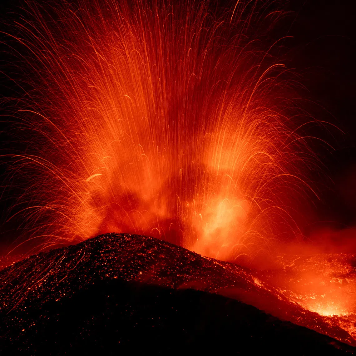Incandescent lava and volcanic material are ejected from a crater during an eruption of Mount Etna, in Sicily, Italy, August 13, 2026. REUTERS/Giuseppe Di Stefano