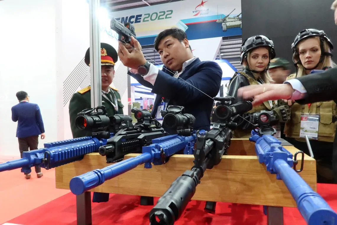 FILE PHOTO: People look at weapons kept on display at the Vietnam International Defence Expo 2022, in Hanoi, Vietnam December 8, 2022.REUTERS/Minh Nguyen/File Photo