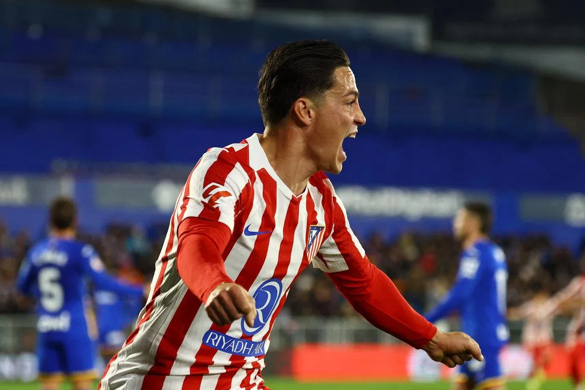 Soccer Football - LaLiga - Getafe v Atletico Madrid - Estadio Coliseum, Getafe, Spain - November 23, 2025 Atletico Madrid's Giacomo Raspadori celebrates their first goal, an own goal scored by Getafe's Domingos Duarte REUTERS/Susana Vera