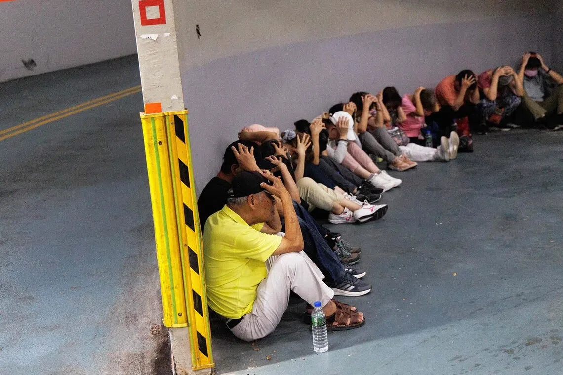TOPSHOT - People take shelter in an underground subway station during a simulation attack in Taipei on August 13, 2026. Millions of people in Taiwan were forced indoors and mobile internet speeds slowed for 30 minutes on August 13, during a simulation of a Chinese attack on the island democracy. The drill was part of Taiwan's annual "Han Kuang" military exercise that aims to prepare the island of 23 million people for a potential Chinese invasion. (Photo by CHENG Yu-chen / AFP)