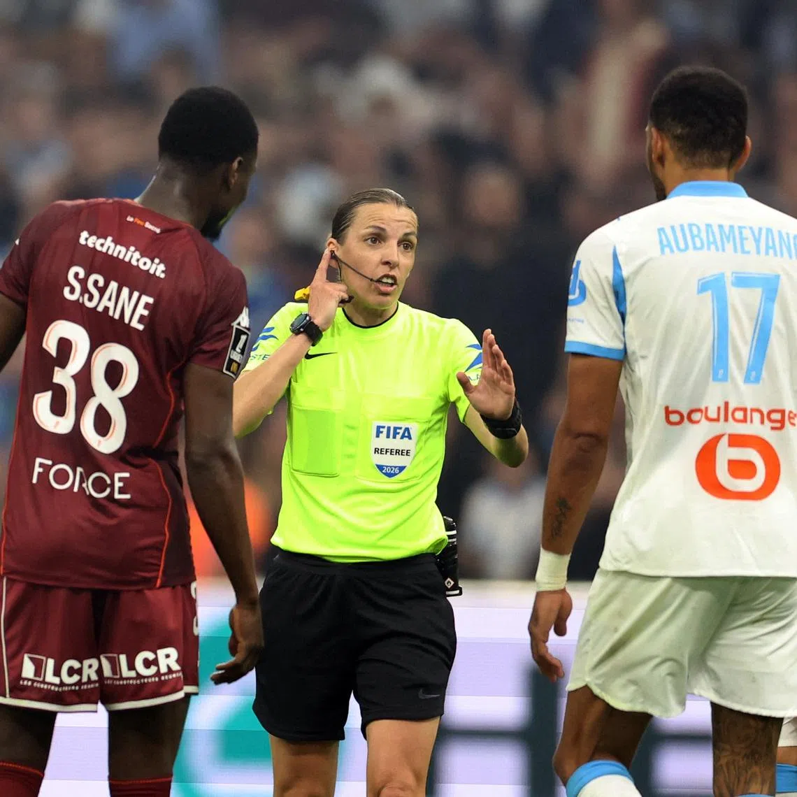 Soccer Football - Ligue 1 - Olympique de Marseille v FC Metz - Orange Velodrome, Marseille, France - April 10, 2026 Referee Stephanie Frappart talks to FC Metz's Sadibou Sane and Olympique de Marseille's Pierre-Emerick Aubameyang REUTERS/Alexandre Dimou
