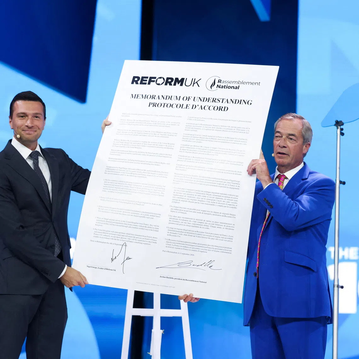 Britain's Reform UK party leader and MP for Clacton, Nigel Farage, and President of the French far-right party Rassemblement National (RN), Jordan Bardella, react after signing a Memorandum of Understanding between the two parties during the Reform UK party conference in Birmingham, Britain, September 4, 2026. REUTERS/Temilade Adelaja