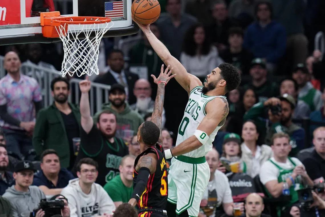 Boston Celtics forward Jayson Tatum drives to the basket against Atlanta Hawks guard Dejounte Murray in the fourth quarter of Game 2 of their NBA play-offs.