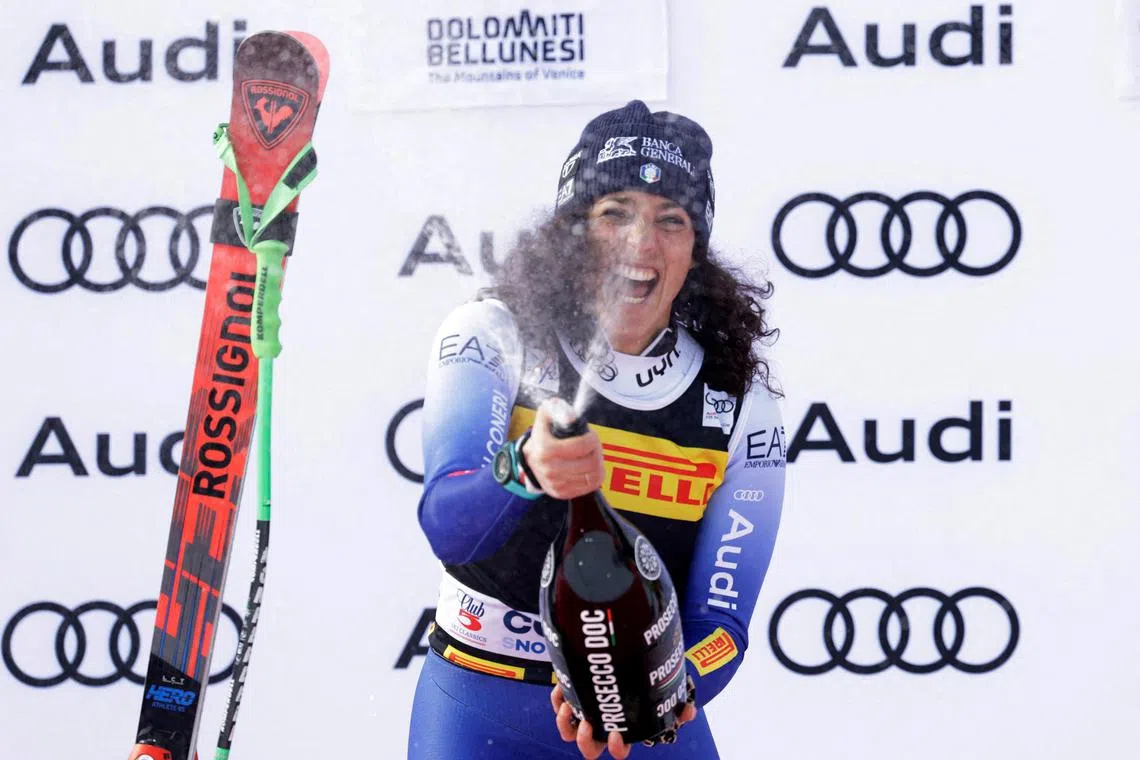 Alpine Skiing - FIS Alpine Ski World Cup - Women's Super G - Cortina d'Ampezzo, Italy - January 19, 2025 Italy's Federica Brignone celebrates with champagne on the podium after winning the Women's Super G REUTERS/Leonhard Foeger