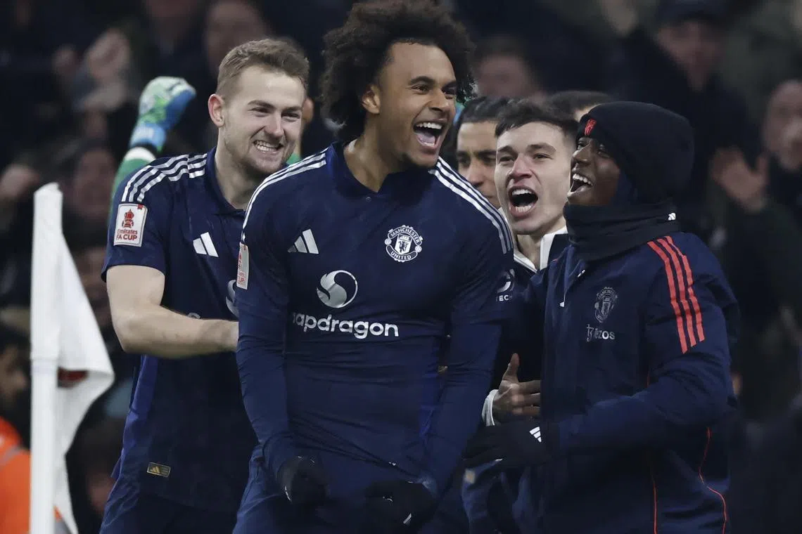 Joshua Zirkzee celebrates with Manchester United teammates after scoring the winning penalty-shootout kick in the FA Cup third-round match against Arsenal in London on Jan 12, 2025.