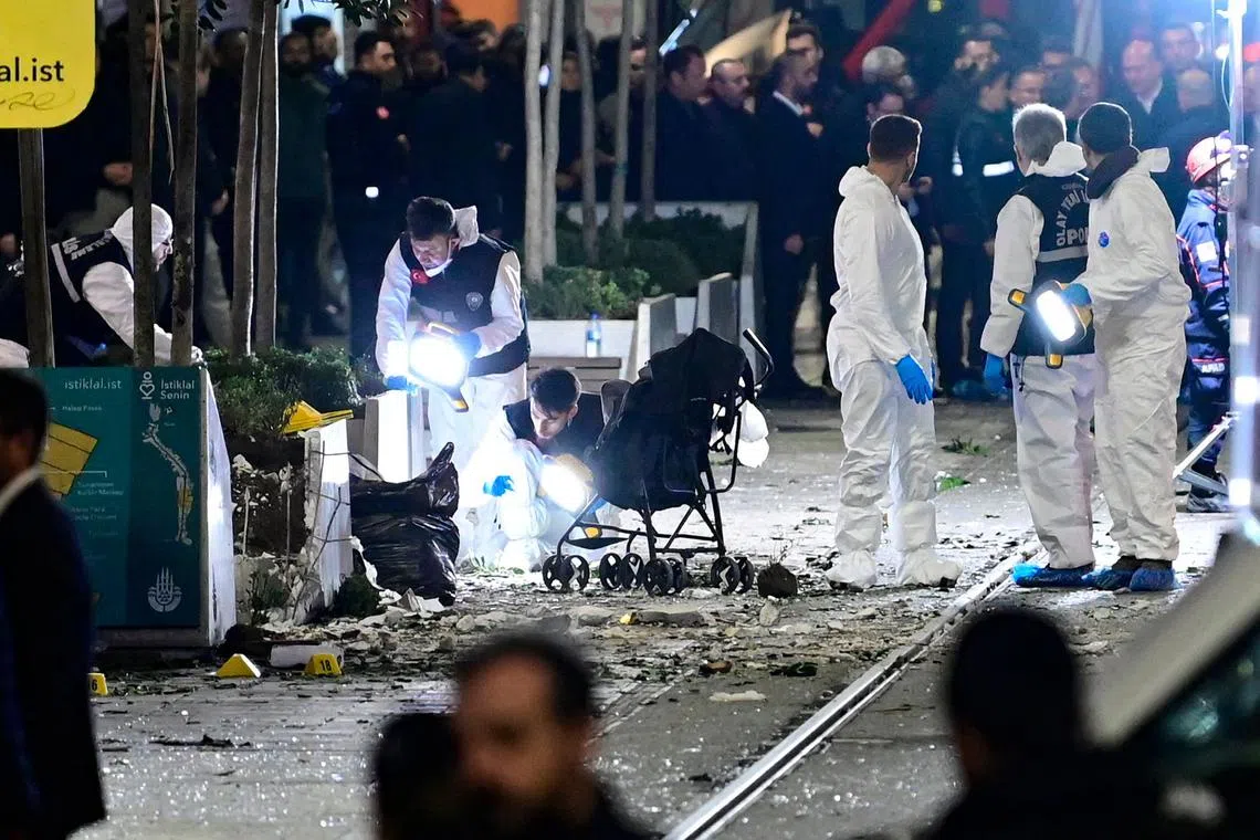 Members of a forensic team work after a strong explosion of unknown origin shook the busy shopping street of Istiklal in Istanbul, on November 13, 2022. - Turkish President condemned the "vile attack" that ripped through central Istanbul, and said it killed six people and wounded over 50 others, on November 13, 2022. 