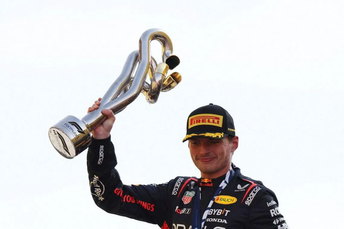 Formula One F1 - Italian Grand Prix - Autodromo Nazionale Monza, Monza, Italy - September 3, 2023 Red Bull's Max Verstappen celebrates with the trophy on the podium after winning the Italian Grand Prix REUTERS/Claudia Greco