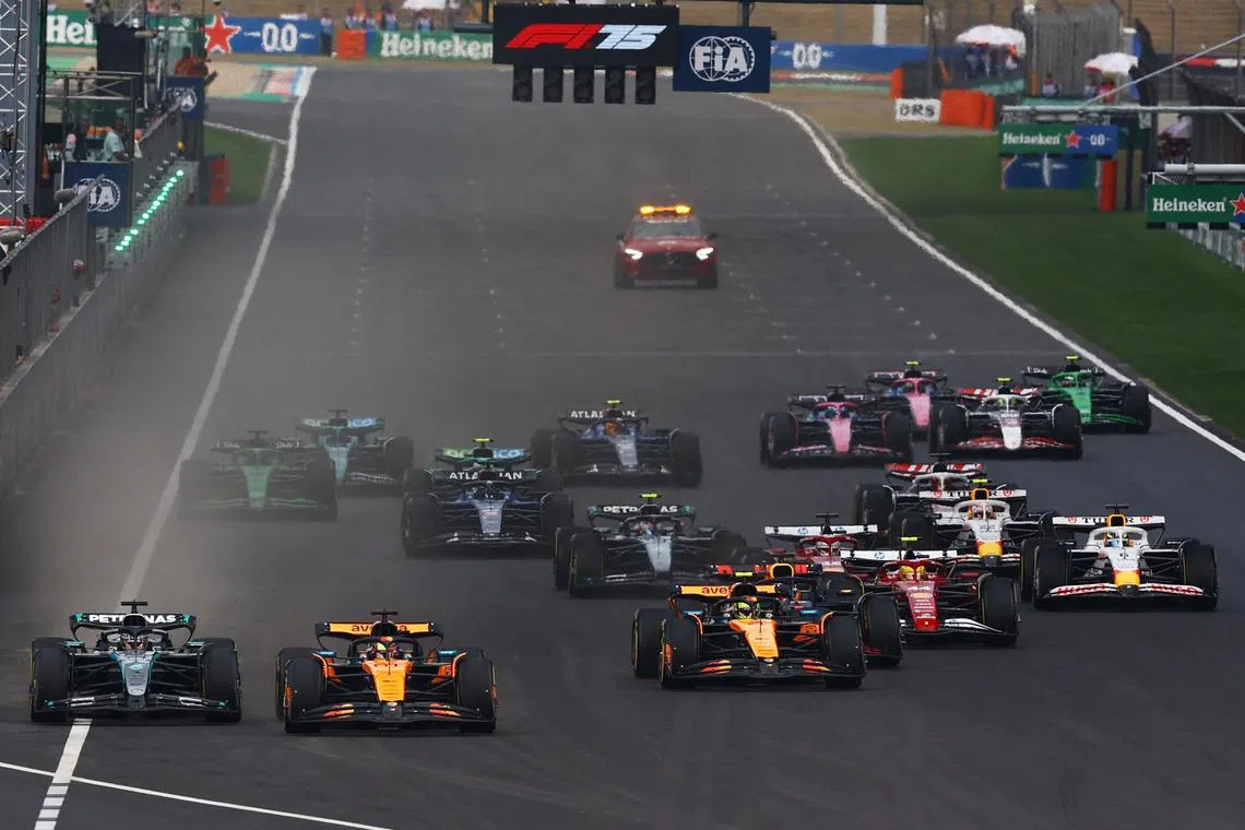 FILE PHOTO: Formula One F1 - Chinese Grand Prix - Shanghai International Circuit, Shanghai, China - March 23, 2025 McLaren's Oscar Piastri and Mercedes' George Russell in action at the start of the race REUTERS/Edgar Su/File Photo