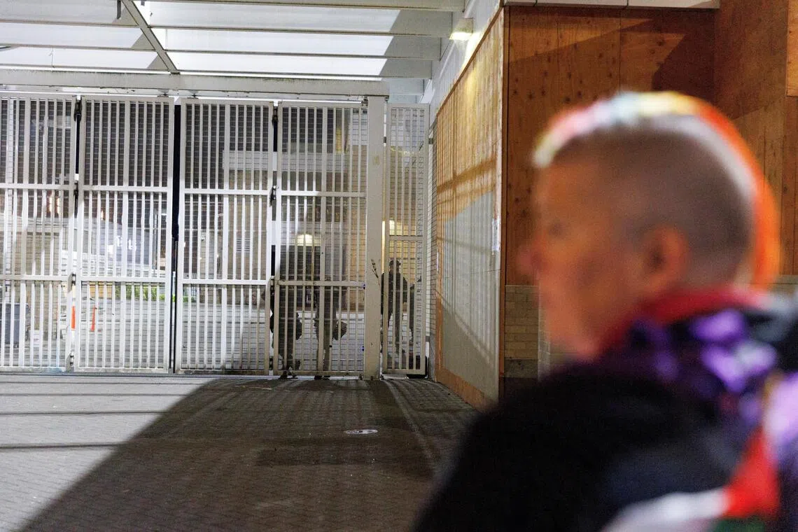 A person stands outside a US Immigration and Customs Enforcement (ICE) facility in Portland, Oregon, on Sept 27, 2025.
