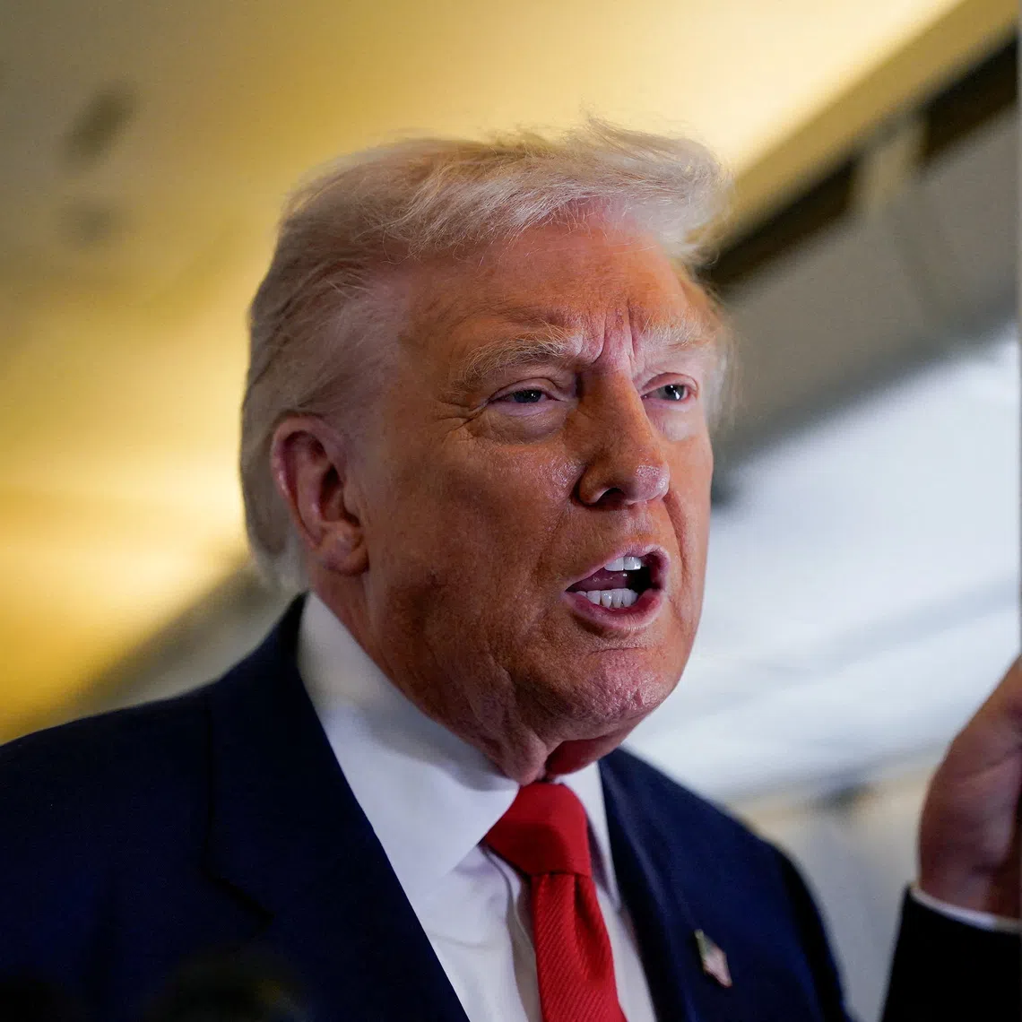 FILE PHOTO: U.S. President Donald Trump speaks to members of the media aboard Air Force One as he departs for Florida from Joint Base Andrews, Maryland, U.S., October 31, 2025. REUTERS/Elizabeth Frantz/File Photo