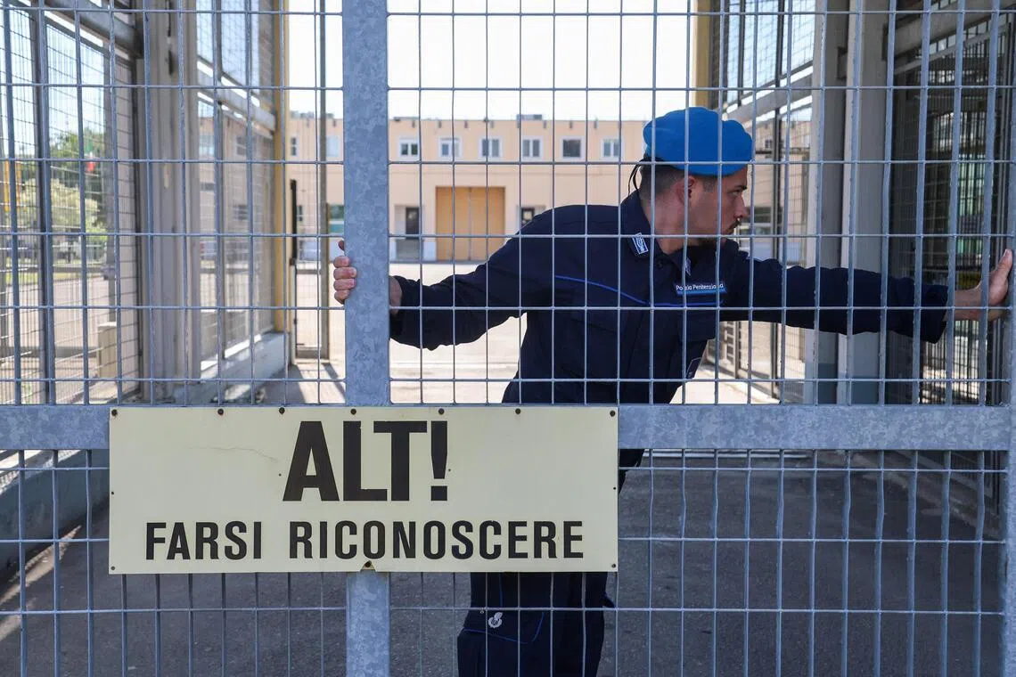 A penitentiary police officer closing a gate of Sant’Anna prison in Modena, Italy, on May 19.