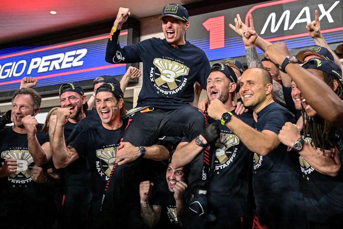 Red Bull's Max Verstappen (centre) celebrates his third world championship with his team, ahead of the Qatar grand prix.