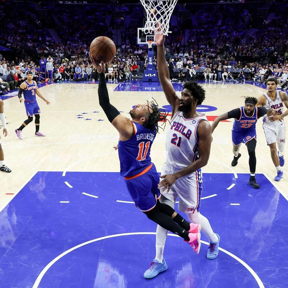 Jalen Brunson attempting a reverse lay-up against Joel Embiid of the Philadelphia 76ers during the New York Knicks' 144-114 Game 4 win at Xfinity Mobile Arena on May 10, 2026. It secured a 4-0 series sweep in the NBA Eastern Conference semi-finals.