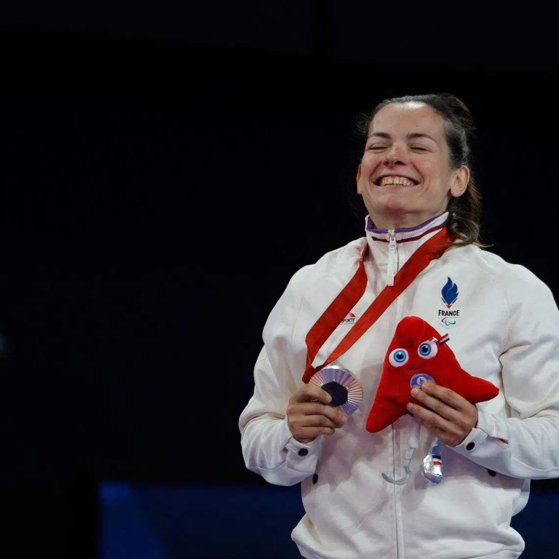 France's Sandrine Martinet celebrates after winning silver in the -48kg J2 classification in judo at the Paris Paralympics.