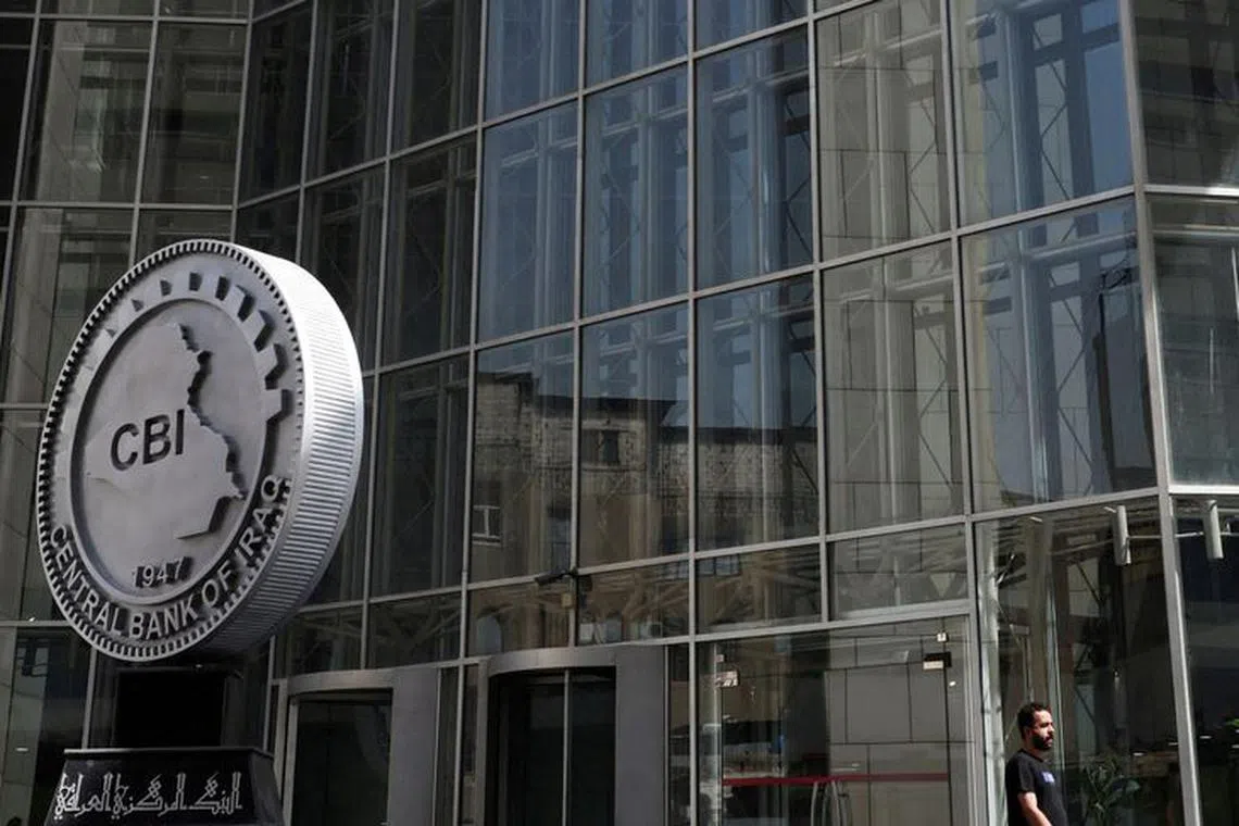 FILE PHOTO: An Iraqi man walks past the headquarters of the Central Bank of Iraq in Baghdad, Iraq August 15, 2023. REUTERS/Ahmed Saad/File Photo