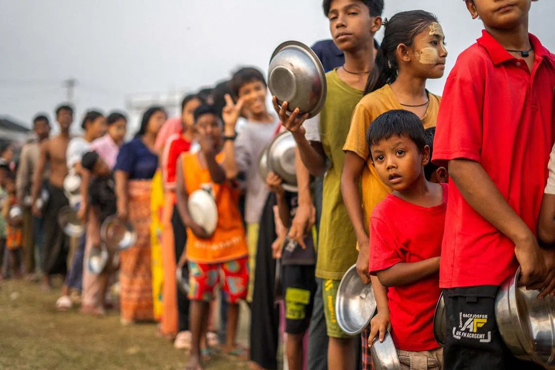 People queuing for food and relief supplies after a strong earthquake in Amarapura, Myanmar, April 1, 2025. 