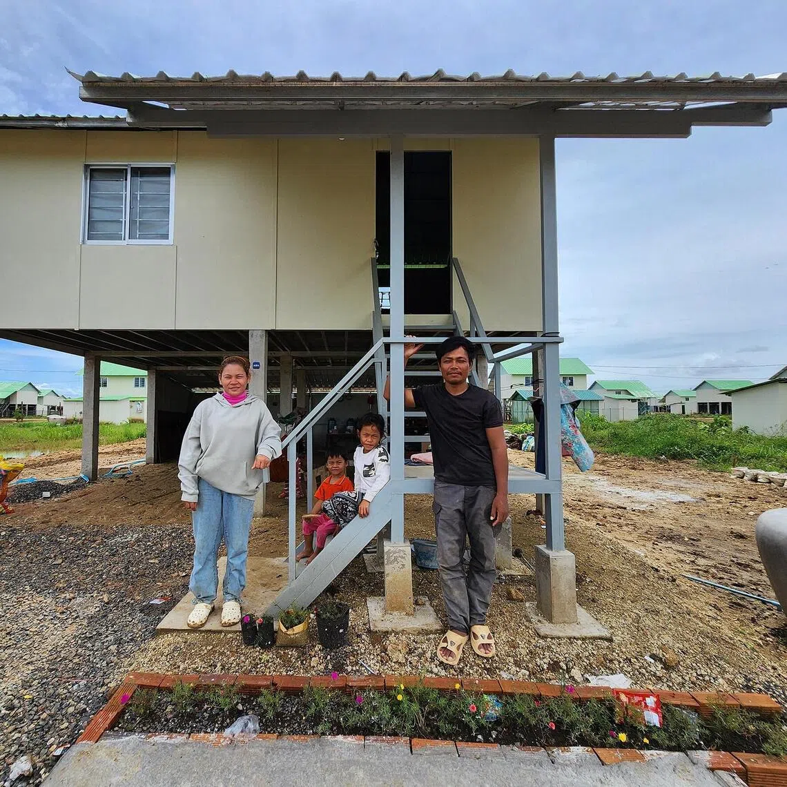 Sun Samnoeun, who lost her house and land in the Thai-Cambodian border conflict, with her husband and children at their temporary home set up by the Cambodian government for those displaced.
