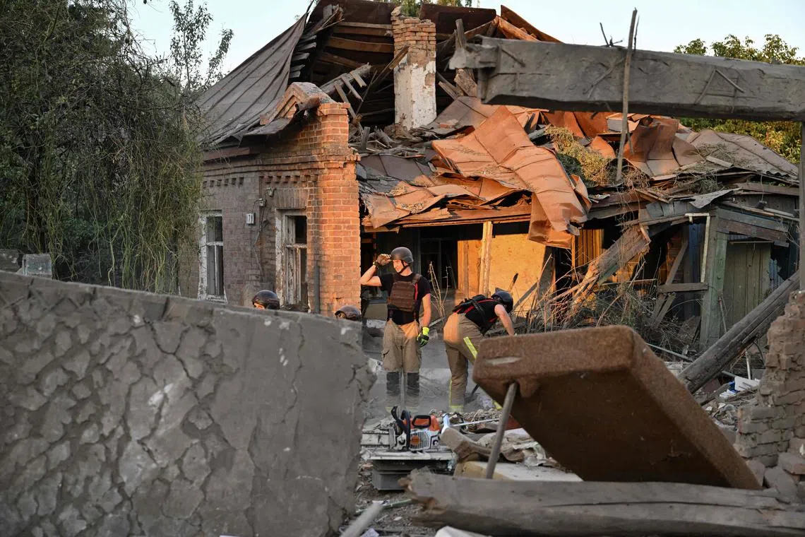 Rescuers clearing the debris of a house destroyed by a Russian strike in Ukraine's Sumy region, on Aug 18.