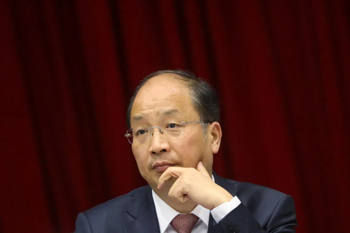 FILE PHOTO: Yi Huiman, chairman of China Securities Regulatory Commission (CSRC), attends a meeting of Fujian delegation on the sidelines of the National People's Congress (NPC), at the Great Hall of the People in Beijing, China March 5, 2019. Picture taken March 5, 2019. REUTERS/Stringer/File photo