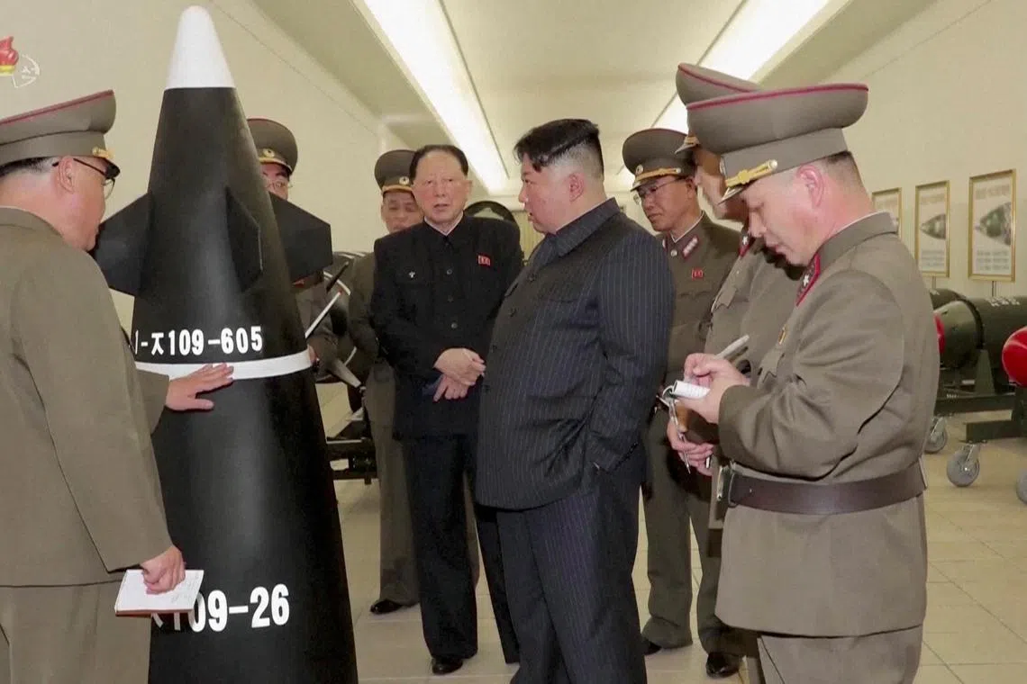 North Korean leader Kim Jong Un is seen inspecting nuclear warheads at an undisclosed location in this undated still image.