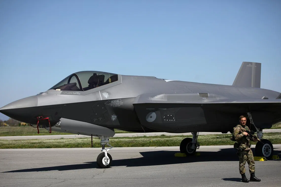 FILE PHOTO: A Dutch soldier stands guard near a Royal Netherlands Air Force F-35 at Graf Ignatievo airbase, Bulgaria, April 14, 2022. REUTERS/Stoyan Nenov/File Photo