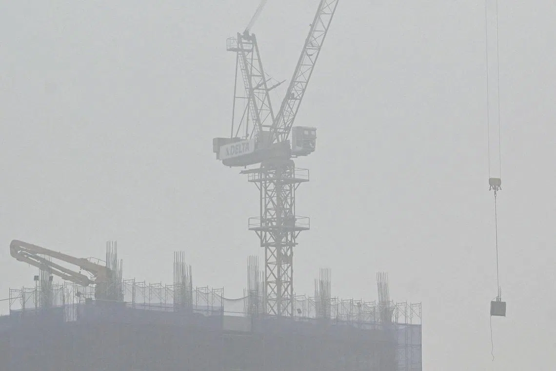 A crane operates at a construction site amid high levels of air pollution in Hanoi on March 5.