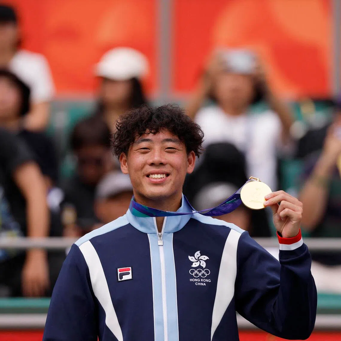 Gold medallist Coleman Wong of Hong Kong poses on the podium during the men’s singles medal ceremony on Oct 3.
