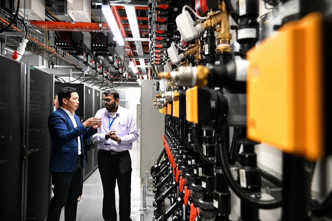 ST20231129_202347382613 Kua Chee Siong/ lhtropic/ 
Navin Raja, 35 senior engineer (right) briefing Mr Alvin Tan, Minister of State (left) for Trade and Industry at the Supply and Return line for the liquid-cooled racks for data centres located in the Tropical Data Centre Testbed at NUS on Nov 29, 2023.
The launch of the world’s first Tropical Data Centre Testbed at NUS.