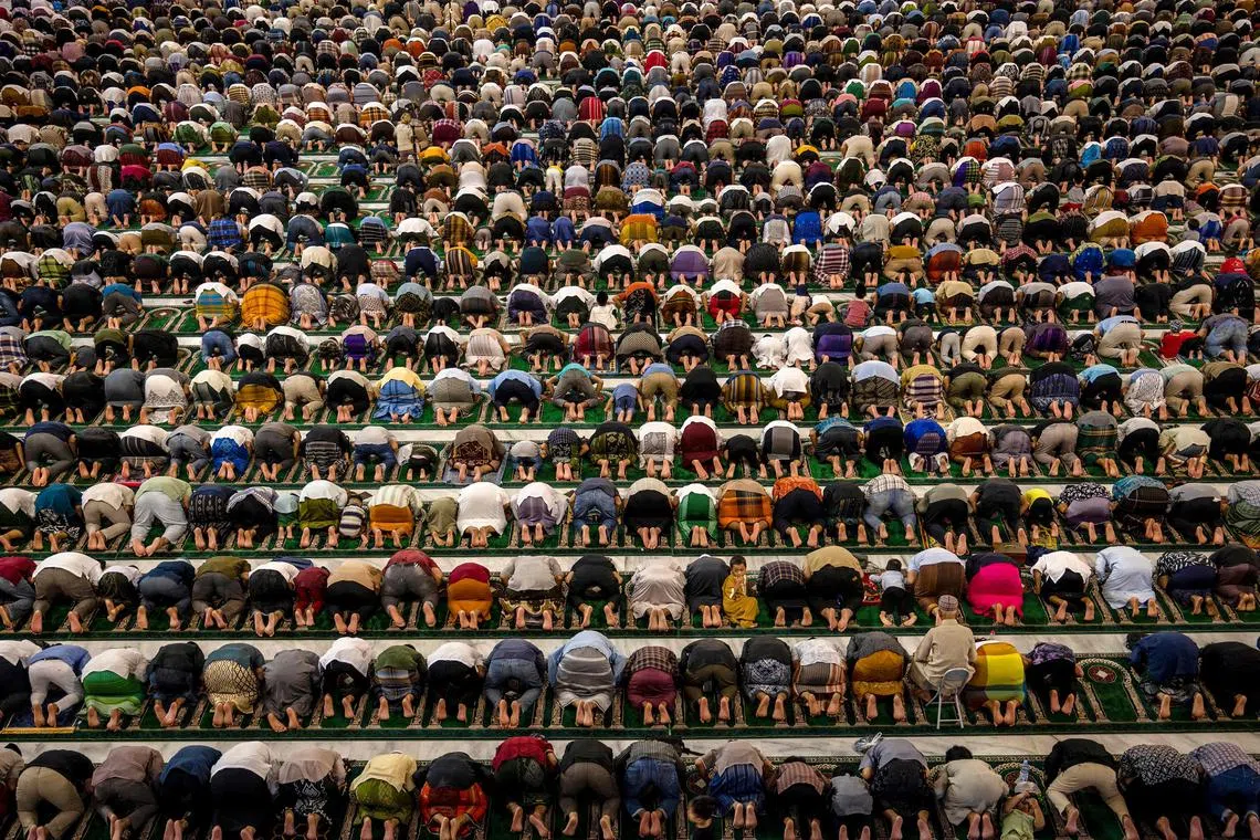 Muslim devotees offering prayers marking the start of Islam's holy fasting month of Ramadan at Al Akbar mosque in Surabaya on Mar 11, 2024. 