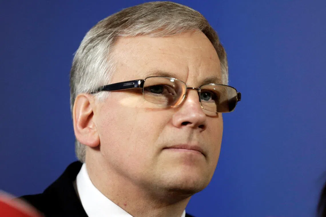 FILE PHOTO: Lithuania's Minister of Finance Rimantas Sadzius listens during a news conference in Riga May 9, 2014. REUTERS/Ints Kalnins/File Photo