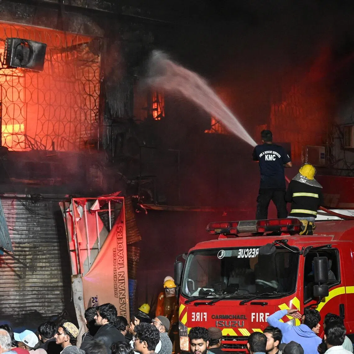Firefighters douse a fire that broke out at a shopping mall in Karachi on Jan 18.