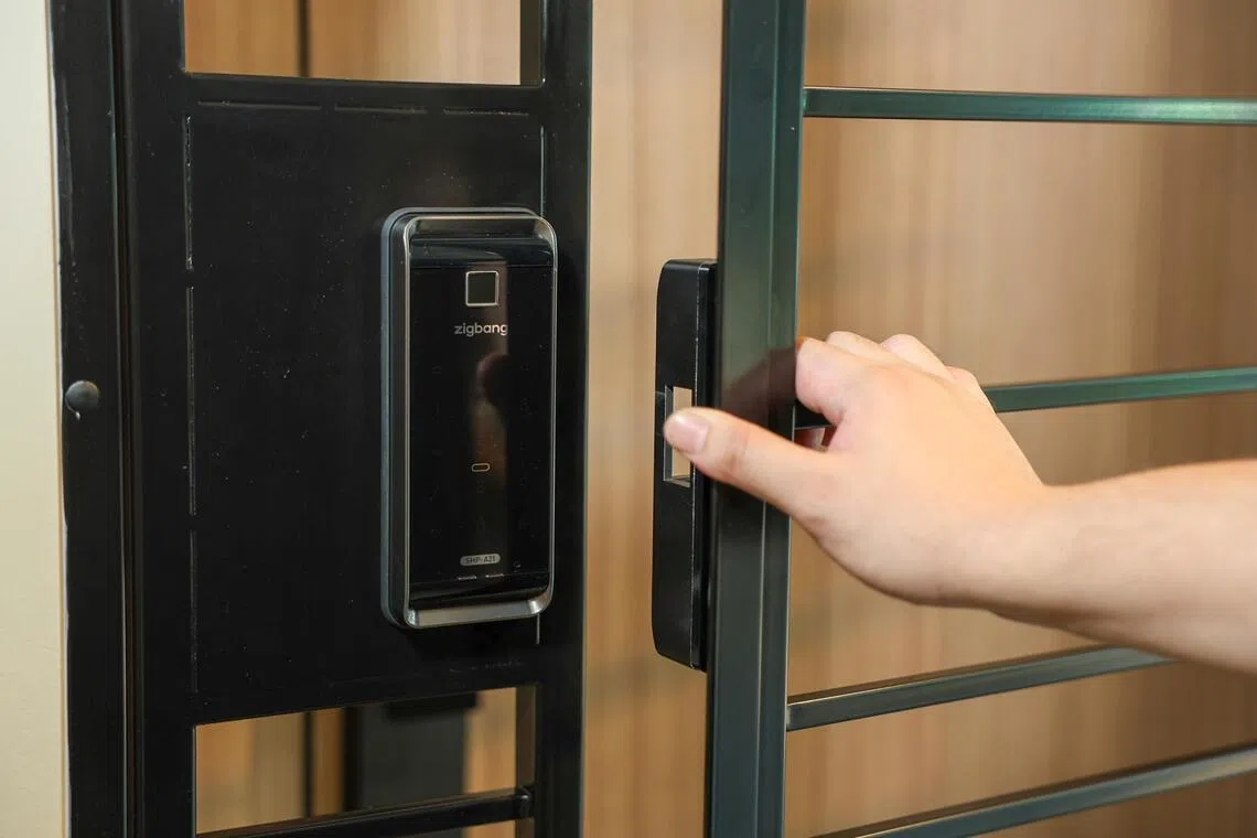 Models of digitally locked HDB BTO gates and doors at AN Digital Lock's showroom.