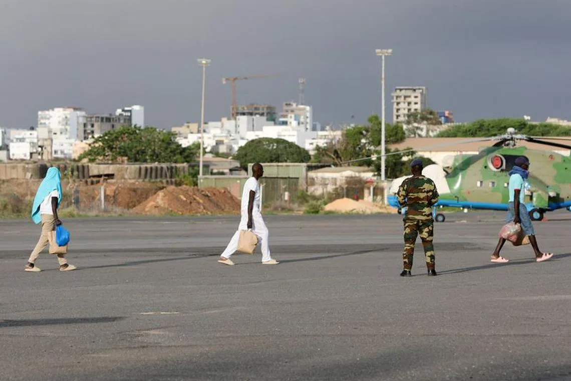 Surviving migrants, from the boat lost at sea during July and found in Cape Verde with several survivors, arrive on the runway at the Dakar-Ouakam Air Base, in Dakar, Senegal August 21, 2023. REUTERS/Ngouda Dione/File Photo