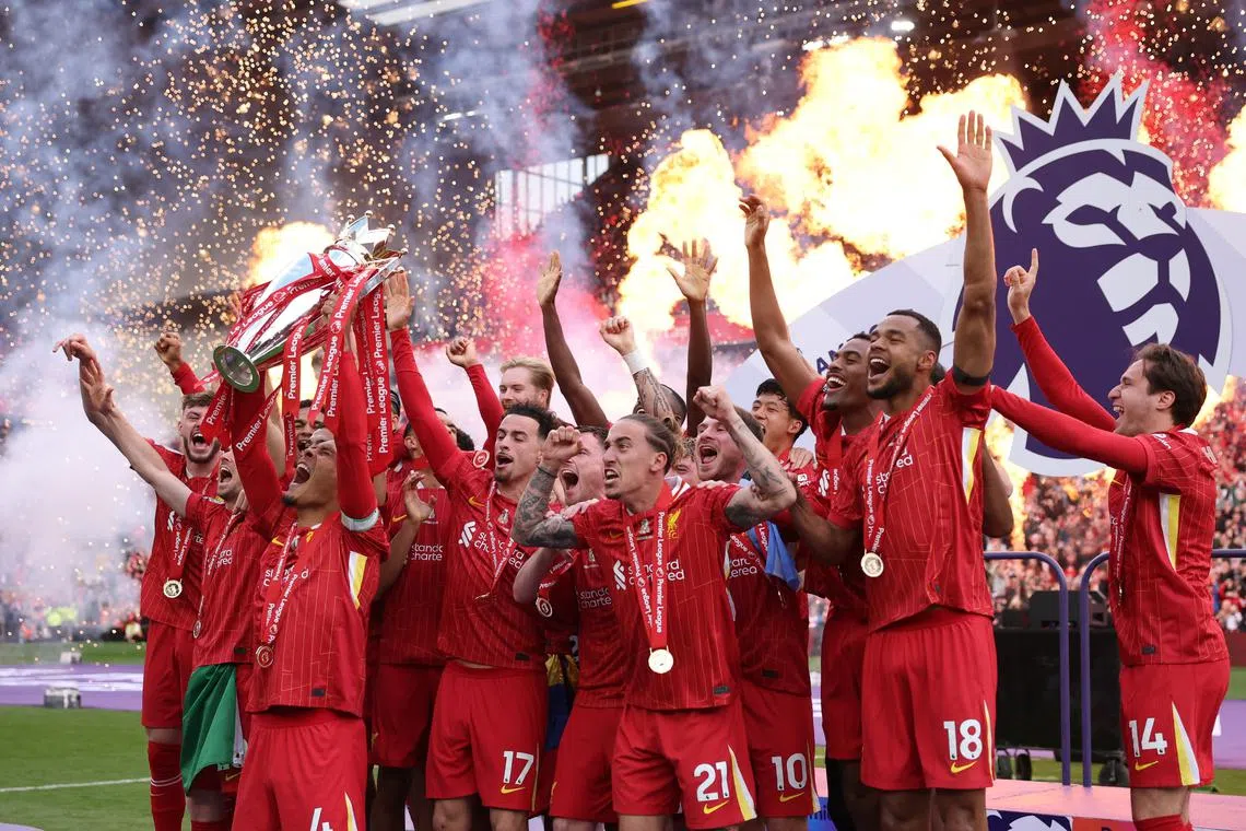 FILE PHOTO: Soccer Football - Premier League - Liverpool v Crystal Palace - Anfield, Liverpool, Britain - May 25, 2025 Liverpool's Virgil van Dijk lifts the trophy as he celebrates with teammates after winning the Premier League REUTERS/Phil Noble/File Photo
