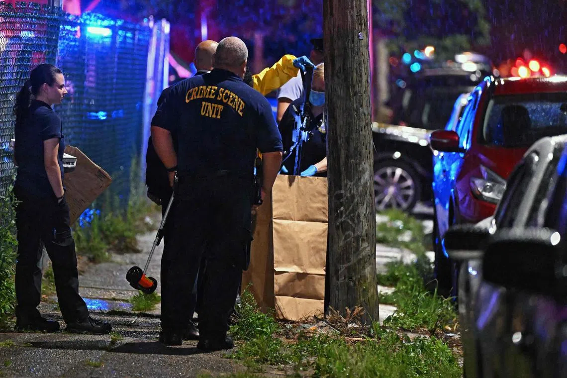 Police recover a rifle at the scene of a shooting in Philadelphia, Pennsylvania, on July 3.