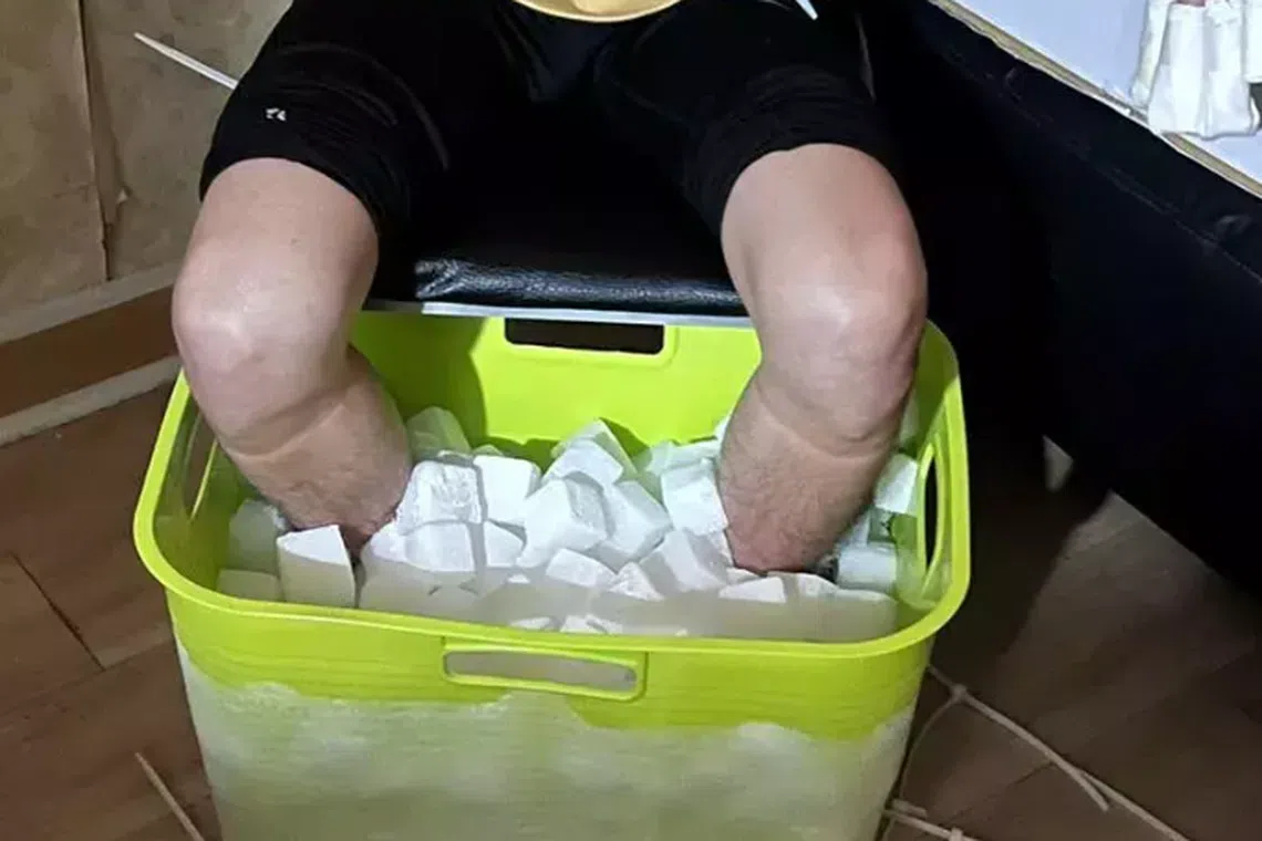 Evidence of Chang sinking his feet into a pail of dry ice taken by his fraud accomplice and obtained by the  Taiwanese authorities.