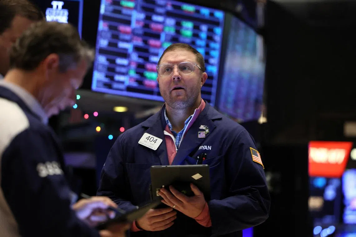 Traders work on the floor of the New York Stock Exchange, in New York City.
