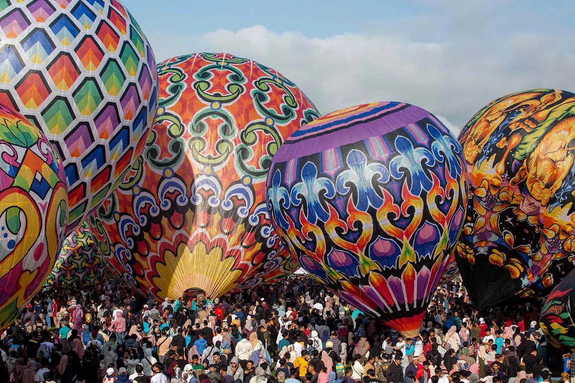 Participants preparing to fly hot air balloons during the traditional hot air balloon festival, an annual event since 1950, during the Eid al-Fitr holiday celebrating the end of the Muslim holy fasting month of Ramadan, in Wonosobo, Central Java, Indonesia, on April 11, 2024. 
