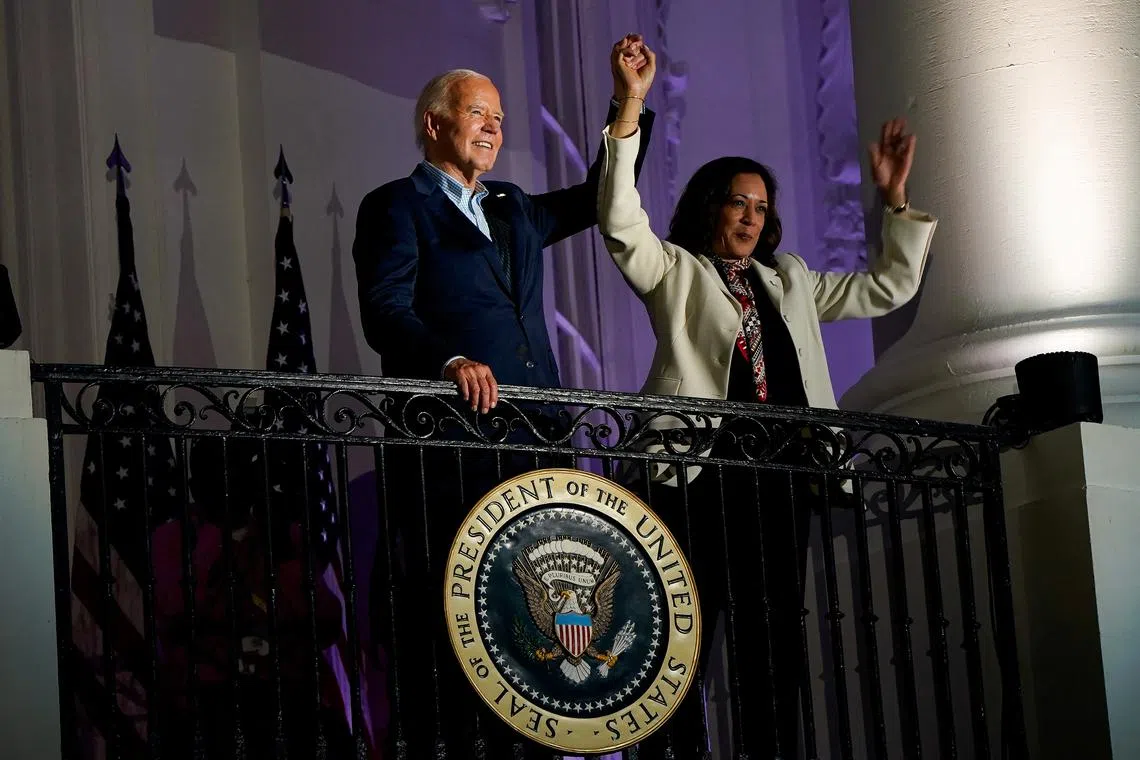 FILE PHOTO: U.S. President Joe Biden and Vice President Kamala Harris raise their hands during an Independence Day celebration in Washington, U.S., July 4, 2024. REUTERS/Elizabeth Frantz/File Photo