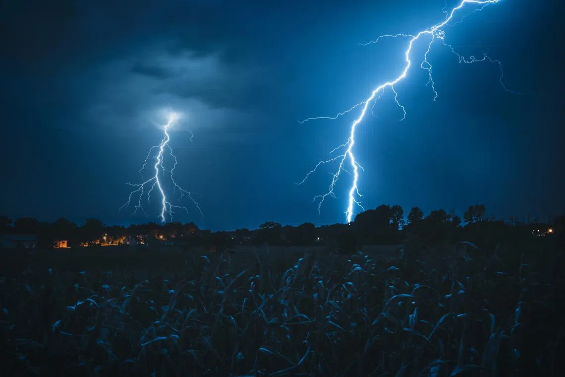 A Malaysian mother and son were struck by lightning while walking home during a light drizzle.