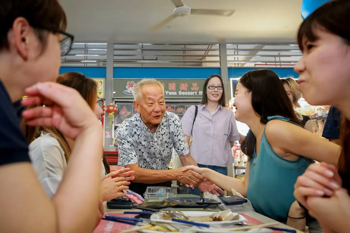 Presidential hopeful Ng Kok Song and his fiancee Sybil Lau greeting vendors and patrons at Tiong Bahru Food Centre, on Aug 5, 2023.