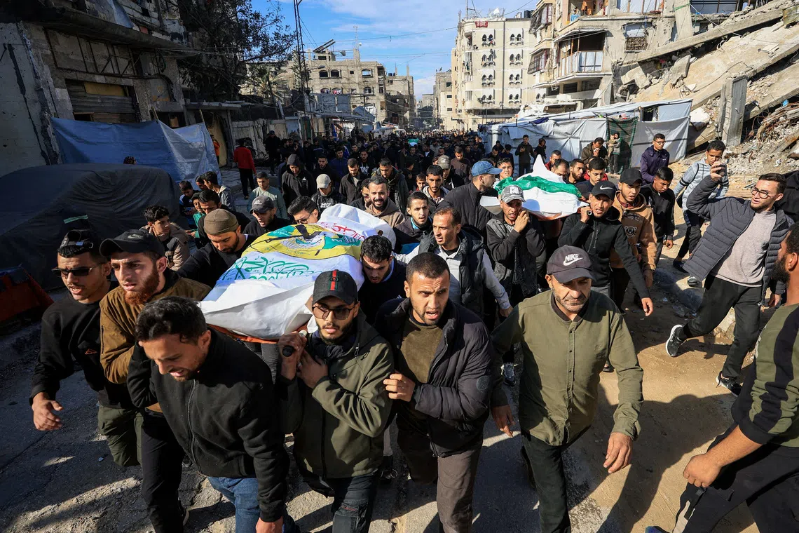 Mourners at the funeral of Hamas senior commander Raed Saed and his aides in Gaza City on Dec 14.