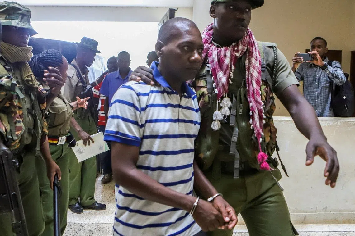 FILE PHOTO: Paul Mackenzie, a Kenyan cult leader accused of ordering his followers, who were members of the Good News International Church, to starve themselves to death in Shakahola forest, is escorted to the Malindi Law Courts in Malindi, Kilifi, Kenya January 17, 2024. REUTERS/Stringer/File Photo
