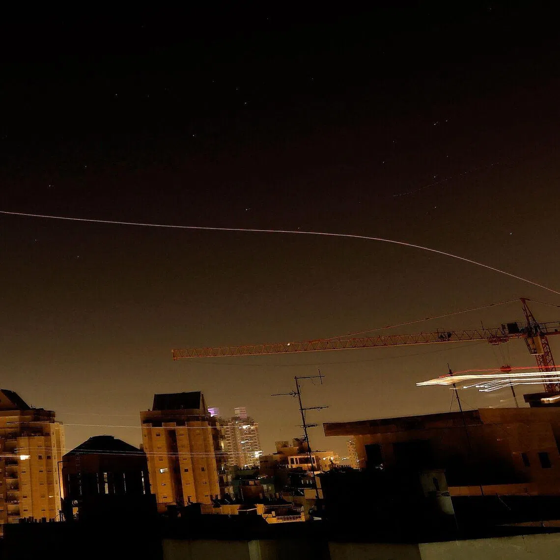 Rocket trails in the sky above the Israeli coastal city of Netanya amid a fresh barrage of Iranian missile attacks on March 17.