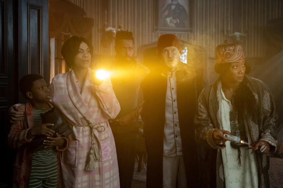 (From left) Chase Dillon, Rosario Dawson, LaKeith Stanfield, Owen Wilson and Tiffany Haddish in Disney's Haunted Mansion.