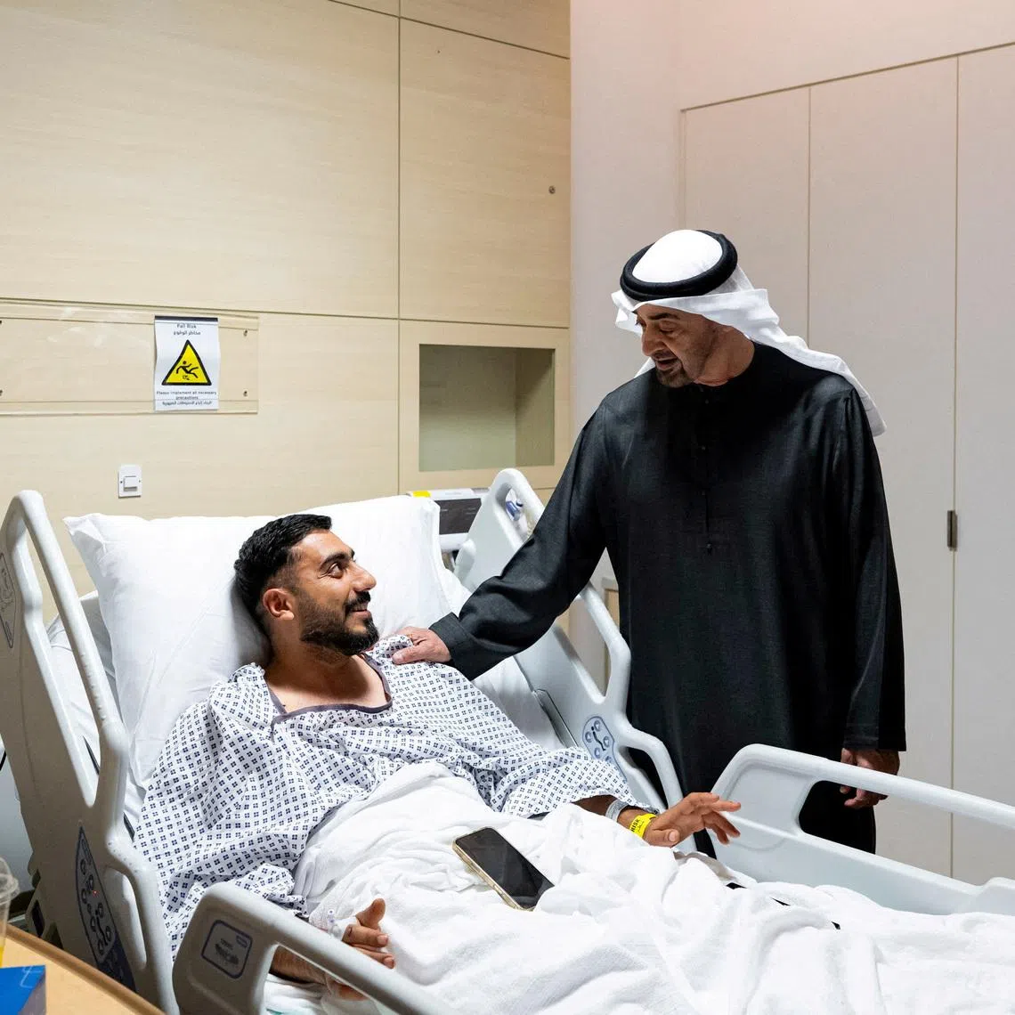 President of the United Arab Emirates Sheikh Mohamed bin Zayed Al Nahyan meets an injured patient receiving treatment at a hospital in Abu Dhabi, United Arab Emirates, March 6, 2026. Abdulla Al Bedwawi/UAE Presidential Court/Handout via REUTERS