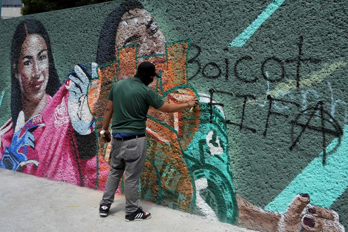A person sprays graffiti during a protest on June 11.